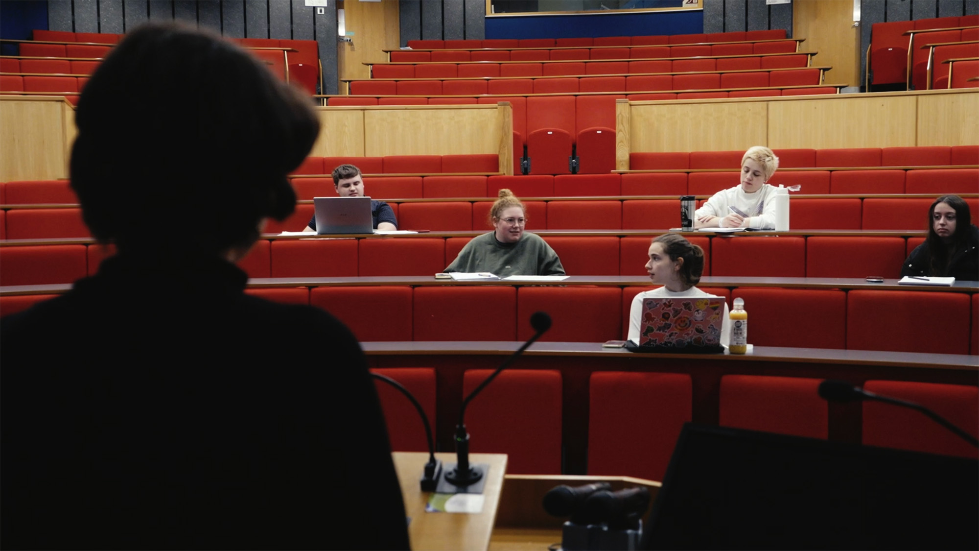 Students in a university lecture hall at Canterbury Christchurch during an outreach presentation about higher education pathways and progression opportunities