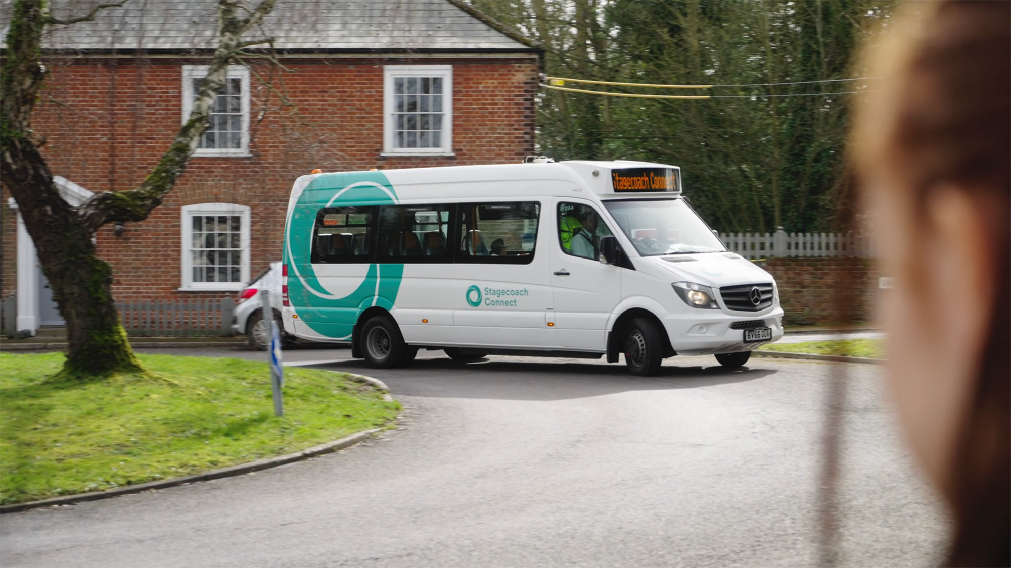 Stagecoach Connect minibus turning onto a road near a brick building