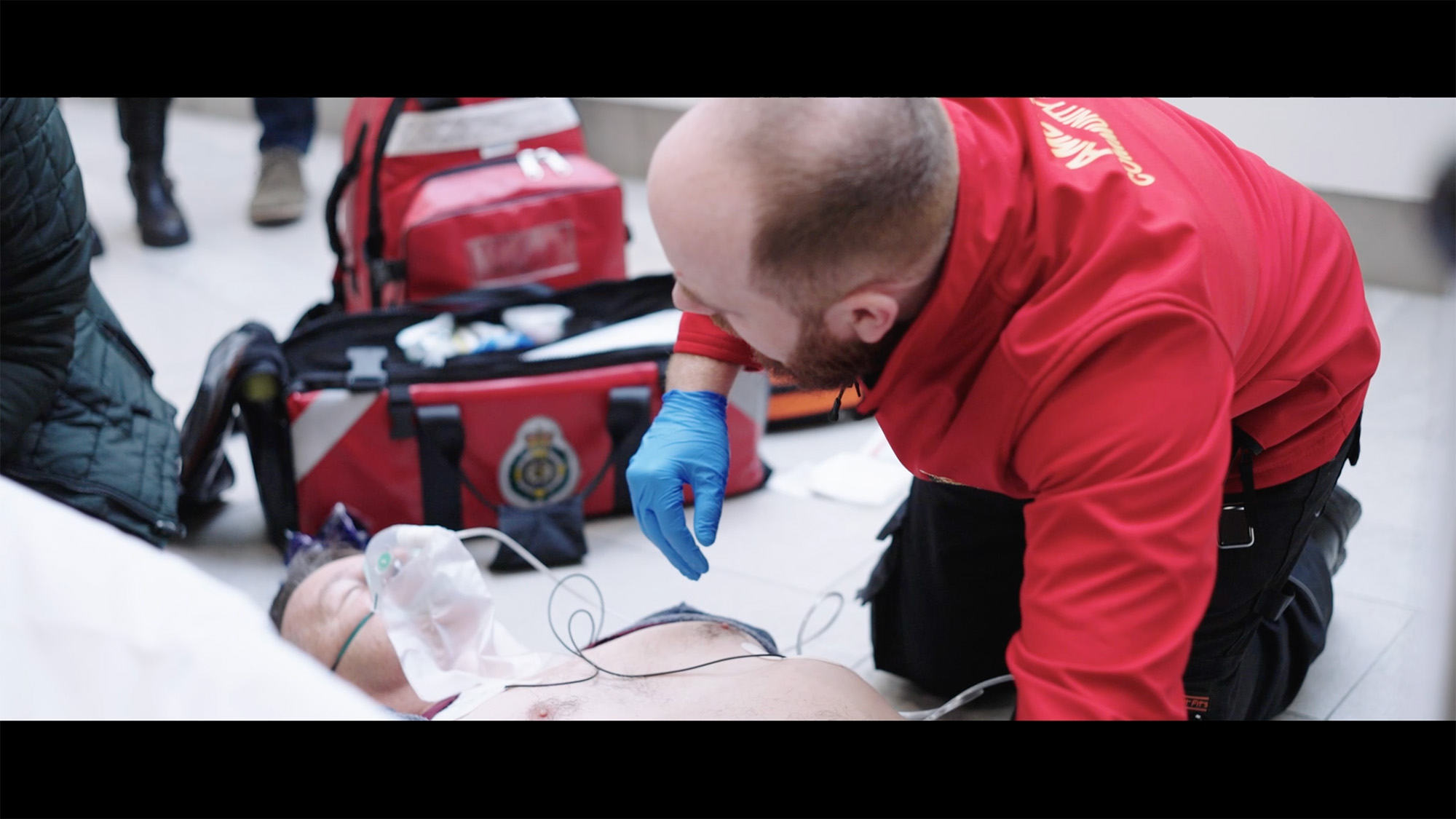 Community First Responder providing emergency medical care to a patient with oxygen support