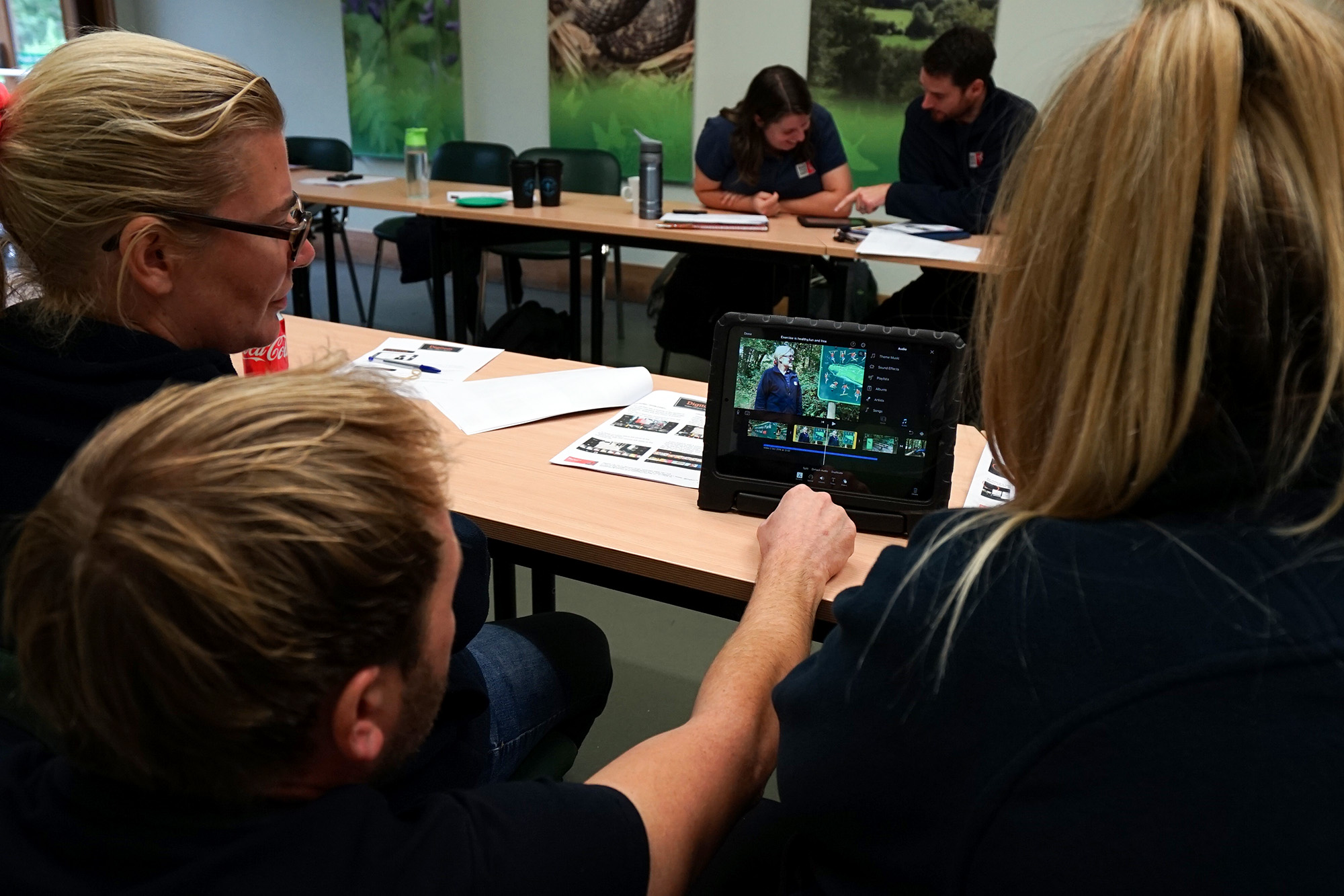 Participants reviewing video content during a Digitom video content training workshop, developing filming, editing and storytelling skills